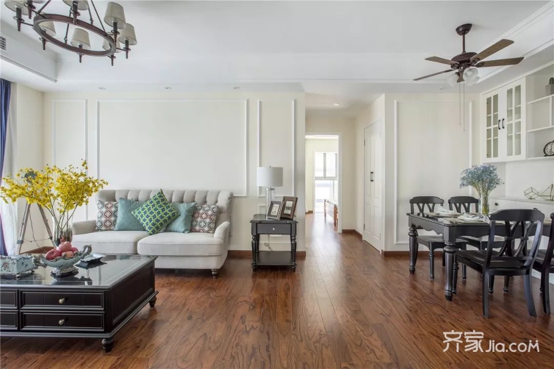 客厅以简约素雅米,灰色为,通铺深色木纹地板,搭配黑色家具,优雅